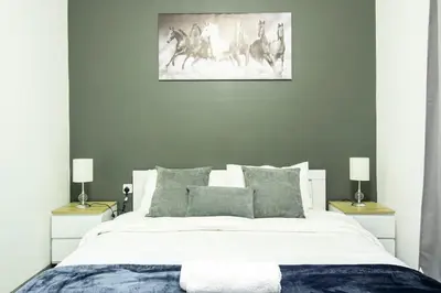 a bedroom with a large white bed with two lamps at Marina Diamond 2 - Very Close to Metro - Cozy in Dubai