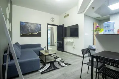 a living room with a couch and a table at Marina Diamond 2 - Very Close to Metro - Cozy in Dubai