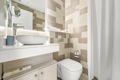 a small bathroom with a sink and a toilet at Luxury 1BR in Seven Palm with Beach Access in Dubai