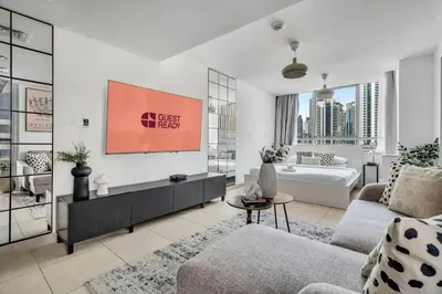 a living room with a couch and a table at GuestReady - Elegant studio in JLT in Dubai
