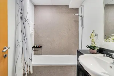 a bathroom with a shower and a sink at GuestReady - Elegant studio in JLT in Dubai