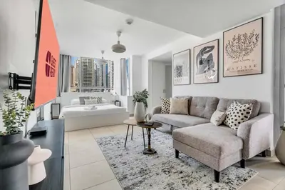 a living room with a couch and a bathroom at GuestReady - Elegant studio in JLT in Dubai