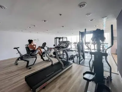 two women in the gym on treadmills at SUNRISE HOMES - A Modern Studio near JBR Beach in Dubai