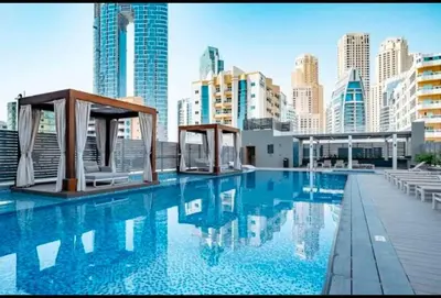 a swimming pool with a city skyline in the background at Beautiful 1 bed apartment Marina I Sleeps 4 in Dubai
