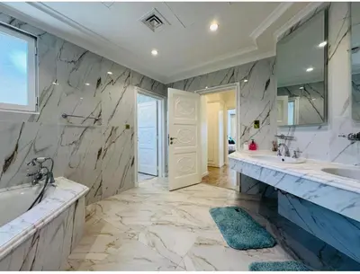 a large bathroom with two sinks and a large mirror at Palm villas in Dubai