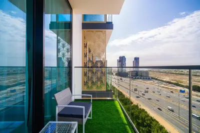 a balcony with a view of a highway at SettlerHomes - Serene JVC 1BR With Modern Luxury in Dubai