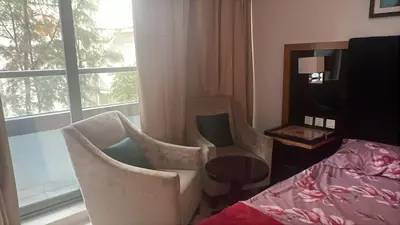 a room with two chairs and a table and a window at Capital bay in Dubai