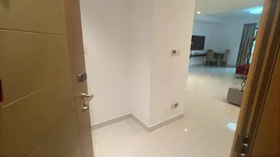 an open door to a room with a white wall at Capital bay in Dubai
