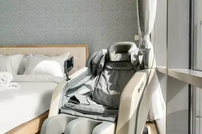 a baby carriage sitting next to a bed at 2BR Canal View Flat with Pool, Gym, 10 min Drive to Dubai Mall in Dubai