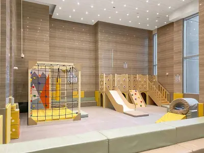 a childrens play room with a slide and slidesktop at 2BR Canal View Flat with Pool, Gym, 10 min Drive to Dubai Mall in Dubai