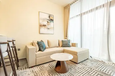 a living room with a couch and a table at Stylish 1BR Business Bay - Near Metro - Balcony with City Views in Dubai