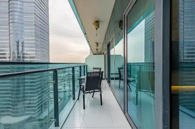 a chair on the balcony of a building at Stylish 1BR Business Bay - Near Metro - Balcony with City Views in Dubai