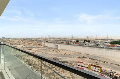 a view of a highway with a construction site at Chic Dubai Studio with Balcony, Pool, Gym, Free Parking Near Expo Metro in Dubai