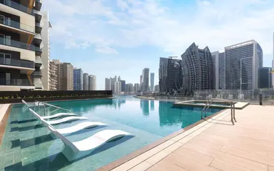 a swimming pool in a city with tall buildings at Lavish Studio at 15 Northside W City Skyline View 3rd floor in Dubai