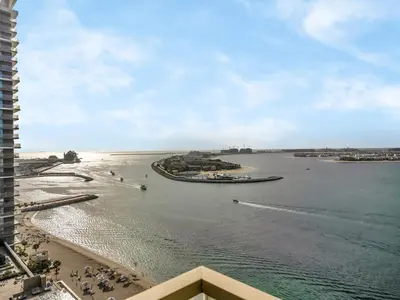 a view of a beach and a body of water at Ultra-Luxury 2 Bedroom Beachfront Escape with Sea Views in Dubai