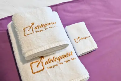 two white towels with the word alfalfari on them at Charming Studio in Meydan by Deleguest in Dubai