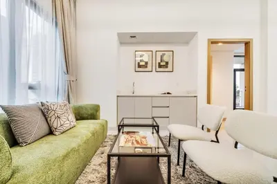 a living room with a couch and a table at Dubai Luxury 4BR Villa in Murooj Al Furjan in Dubai