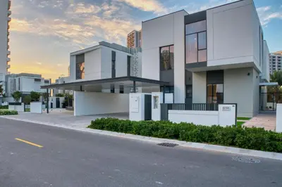 a white house on the side of a street at Dubai Luxury 4BR Villa in Murooj Al Furjan in Dubai