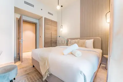 a bedroom with a large white bed with white pillows at Near Dubai Marina Canal 2BR with Pool and City Views Balcony, Studio One, Dubai Marina by Deluxe Holiday Homes in Dubai
