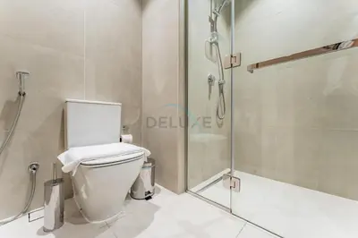 a bathroom with a toilet and a shower at Near Dubai Marina Canal 2BR with Pool and City Views Balcony, Studio One, Dubai Marina by Deluxe Holiday Homes in Dubai