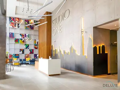 a lobby with a wall mural of a city at Near Dubai Marina Canal 2BR with Pool and City Views Balcony, Studio One, Dubai Marina by Deluxe Holiday Homes in Dubai