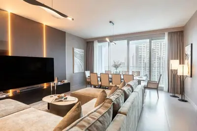 a living room with a large couch and a flat screen tv at Royal 4BR Burj Khalifa View Dubai Mall in Dubai