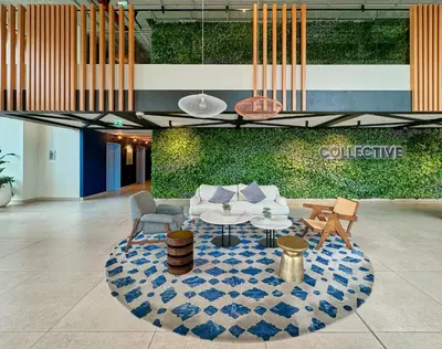 a lobby with a couch and a table and chairs at Stylish 2BR Apartment Steps from Dubai Hills Mall in Dubai