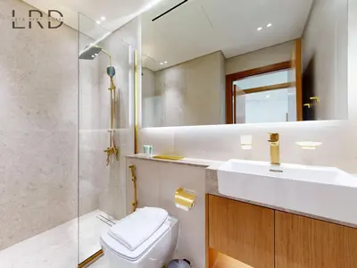 a bathroom with a toilet and a sink and a shower at Brand New and Modern Smart Home 1BR in Dubai