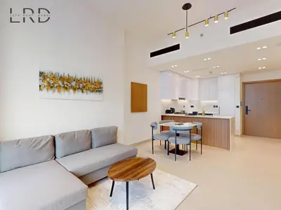 a living room with a couch and a table at Brand New and Modern Smart Home 1BR in Dubai