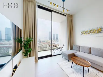 a living room with a couch and a large window at Brand New and Modern Smart Home 1BR in Dubai