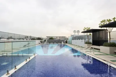 a swimming pool on the roof of a building at Livbnb-Stylish and Spacious 1BR Apartment with Private Balcony in Dubai