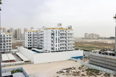 an aerial view of a large white building at Livbnb-Stylish and Spacious 1BR Apartment with Private Balcony in Dubai