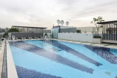 a swimming pool on the roof of a building at Livbnb-Stylish and Spacious 1BR Apartment with Private Balcony in Dubai