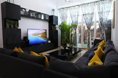 a living room with a couch and a tv at Nice Place in Dubai