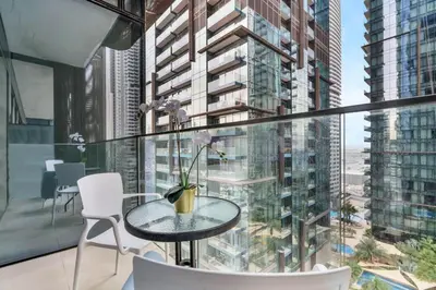 a table and chairs on a balcony with a view of a city at GuestReady - Marina Gate Studio Suite in Dubai