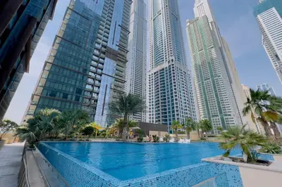 a swimming pool in a city with tall buildings at GuestReady - Marina Gate Studio Suite in Dubai