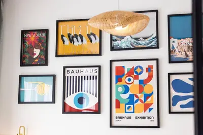 a wall with framed pictures on a wall at Urbane 1BR in Dubai Hills in Dubai