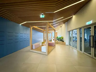 a lobby of a building with a room with benches at Urbane 1BR in Dubai Hills in Dubai