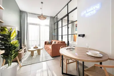 a living room with a table and a couch at Urbane 1BR in Dubai Hills in Dubai