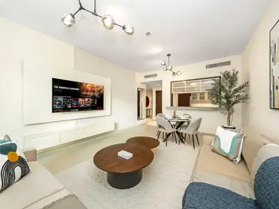 a living room with a couch and a table at Stylish 1BR - Burj Khalifa View in Dubai