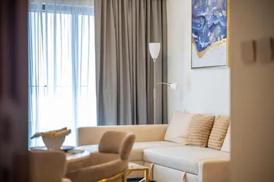 a living room with a couch and a chair at Rooftop Lounge - Walk to Dubai Mall & Burj Khalifa - Downtown in Dubai