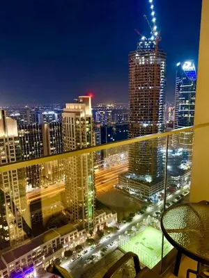 a view of a city skyline at night at Rooftop Lounge - Walk to Dubai Mall & Burj Khalifa - Downtown in Dubai