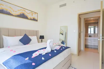 a bedroom with a bed with two stuffed animals on it at Rooftop Lounge - Walk to Dubai Mall & Burj Khalifa - Downtown in Dubai
