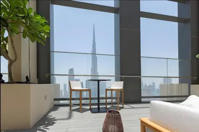 a living room with a table and two chairs at Rooftop Lounge - Walk to Dubai Mall & Burj Khalifa - Downtown in Dubai