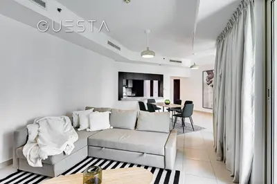 a living room with a couch and a table at The Views & Greens - Mosela Tower, Dubai in Dubai