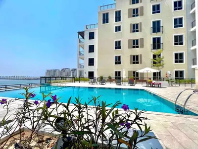 a swimming pool in front of a building at 50 Shades of Grey Luxury Apartment near Beach in Dubai