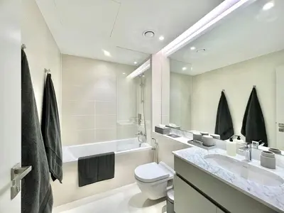 a bathroom with a sink and a toilet and a tub at 50 Shades of Grey Luxury Apartment near Beach in Dubai