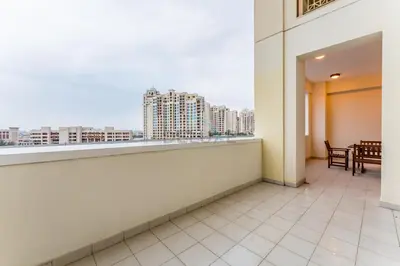 a balcony with a view of a city at Glance at the Royal Atlantis Right by Dubai Top Spots 2BR, Marina Apartments 3, Palm Jumeirah by Deluxe Holiday Homes in Dubai