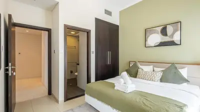 a bedroom with a large bed and a bathroom at Breathtaking Marina 2BR in Iconic Cayan Tower - 7AB08 in Dubai