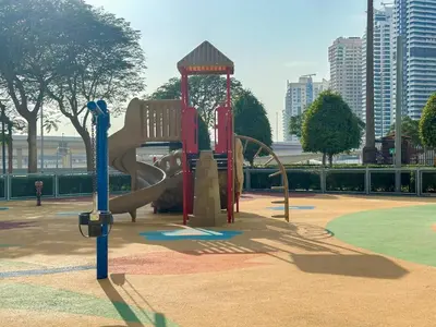 a playground with a slide in a park at Higuest - Lake-view Studio in JLT in Dubai